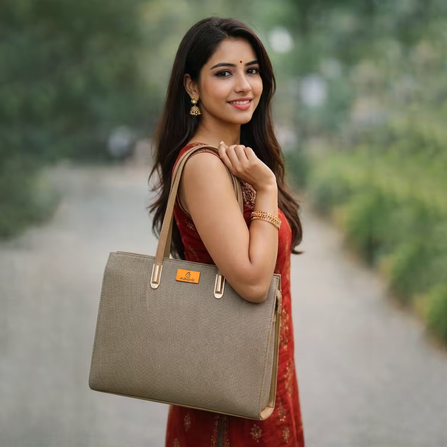 Woman holding a beige handbag outdoors with greenery in the background
