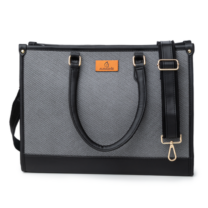 Gray tote bag with black straps and gold hardware on a white background