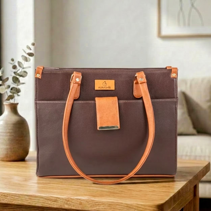 Brown handbag with orange handles on a wooden table in a home setting