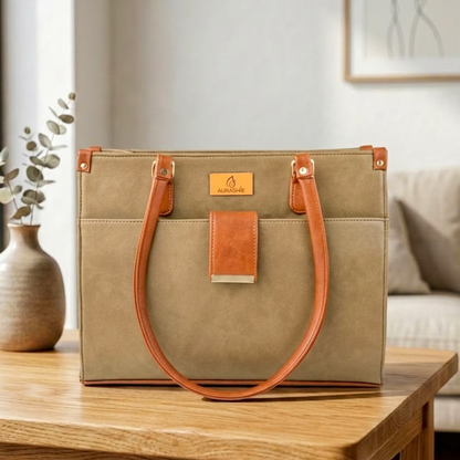 Green handbag with brown handles on a wooden table in a home setting