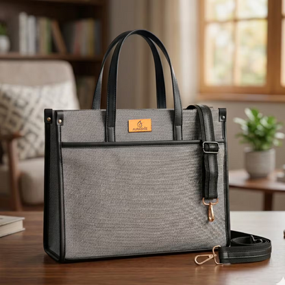 Gray handbag with black accents on a wooden table in a home setting