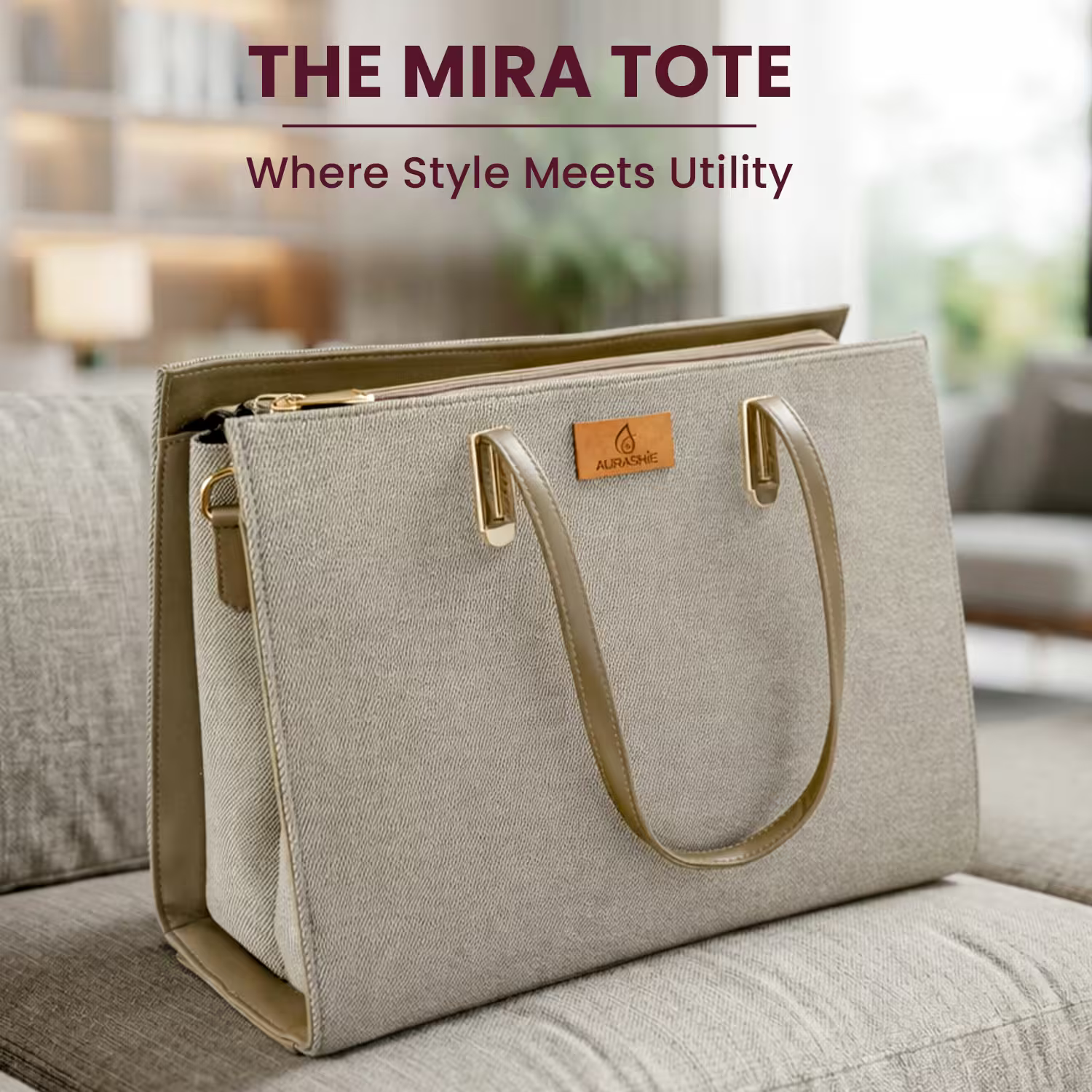 Gray tote bag with brown handles on a couch, featuring the Mira Tote branding.