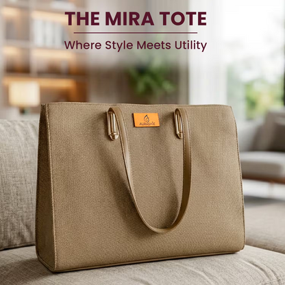 Beige tote bag with 'The Mira Tote' branding on a blurred indoor background