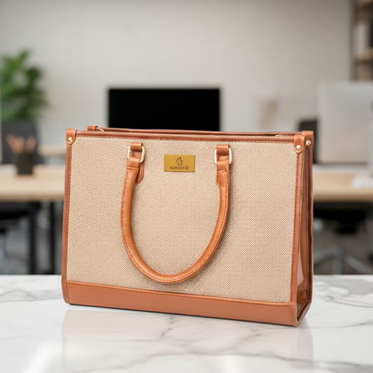 Beige handbag with brown handles and trim on a marble surface, blurred office background