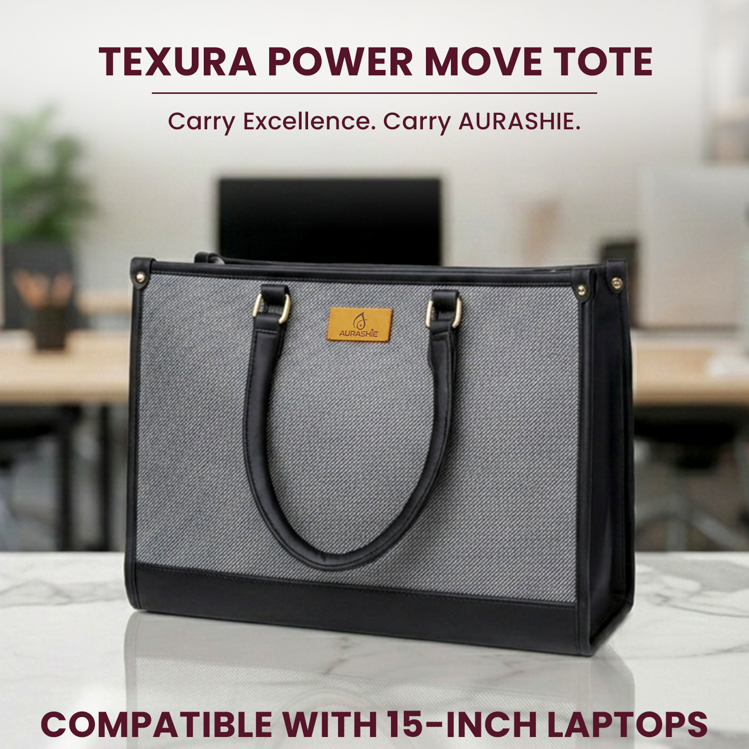 Gray and black Texura Power Move Tote bag on a desk with blurred office background