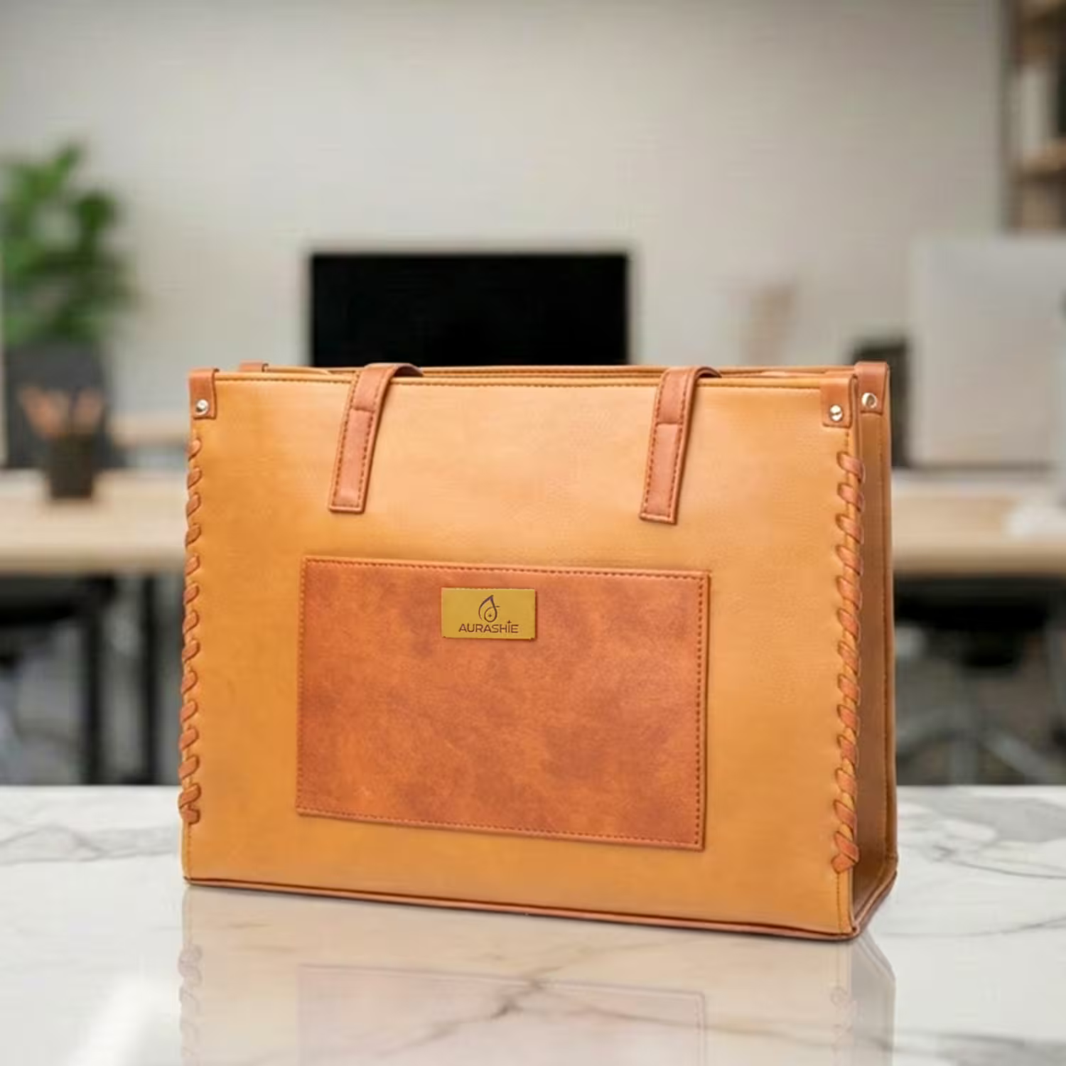 Brown leather bag with a brand logo on a marble surface