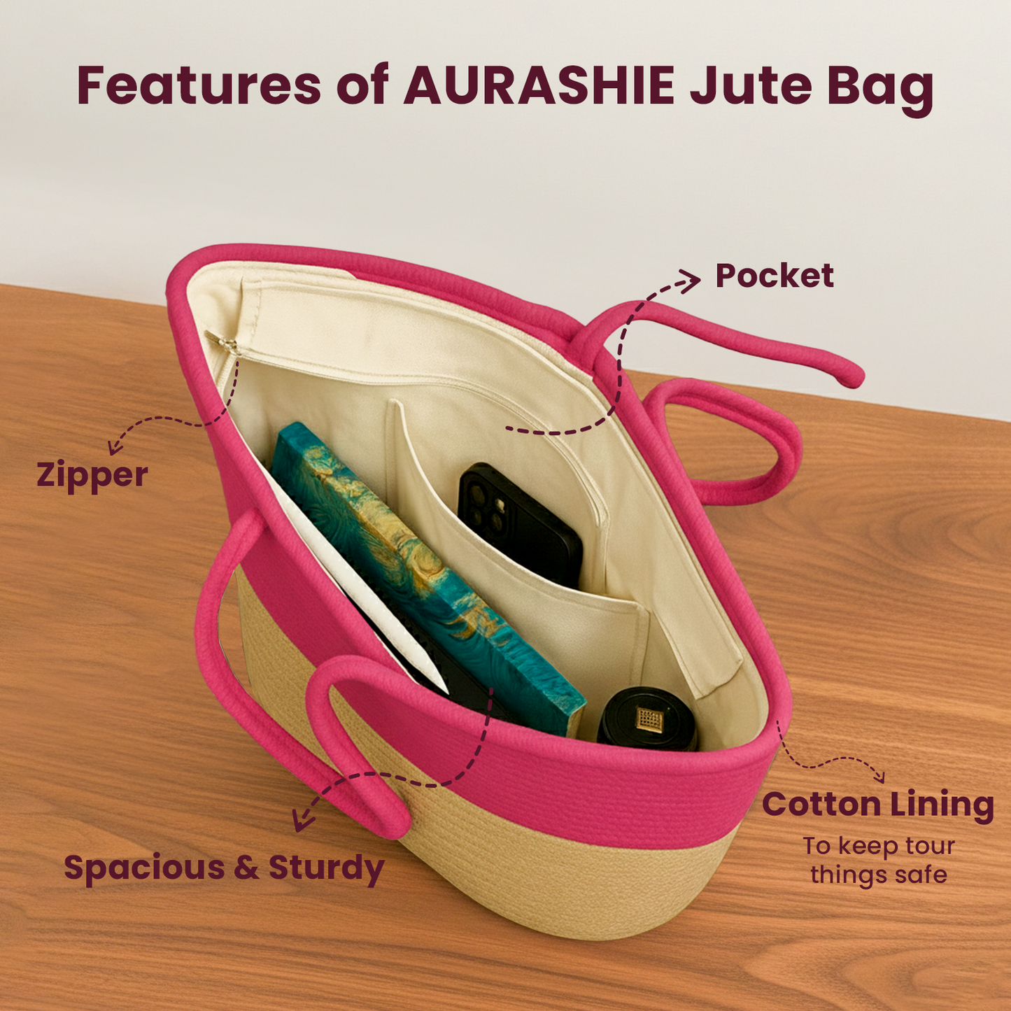 Aushnie jute bag with pink handle and lining, showing features on a wooden surface.