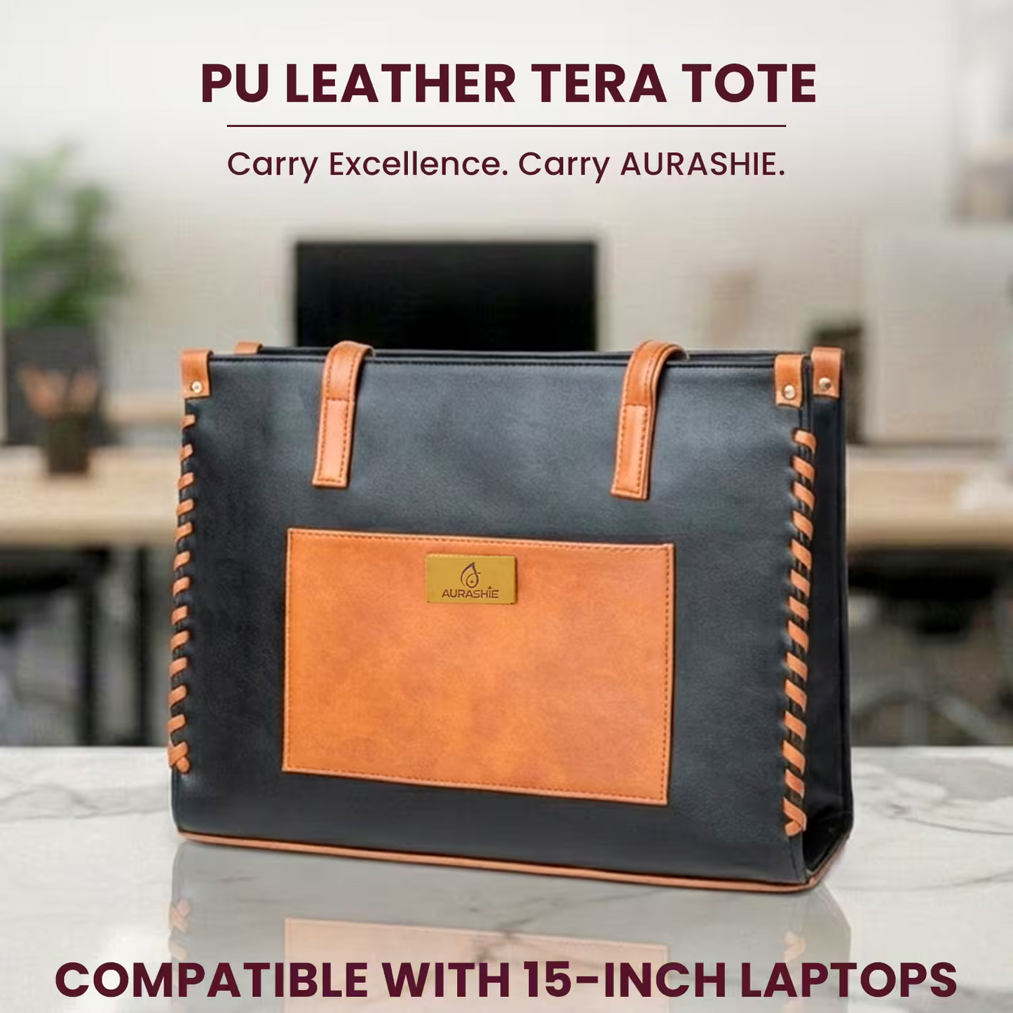 Black and brown PU leather tote bag with AURASHIE branding on a blurred office background.