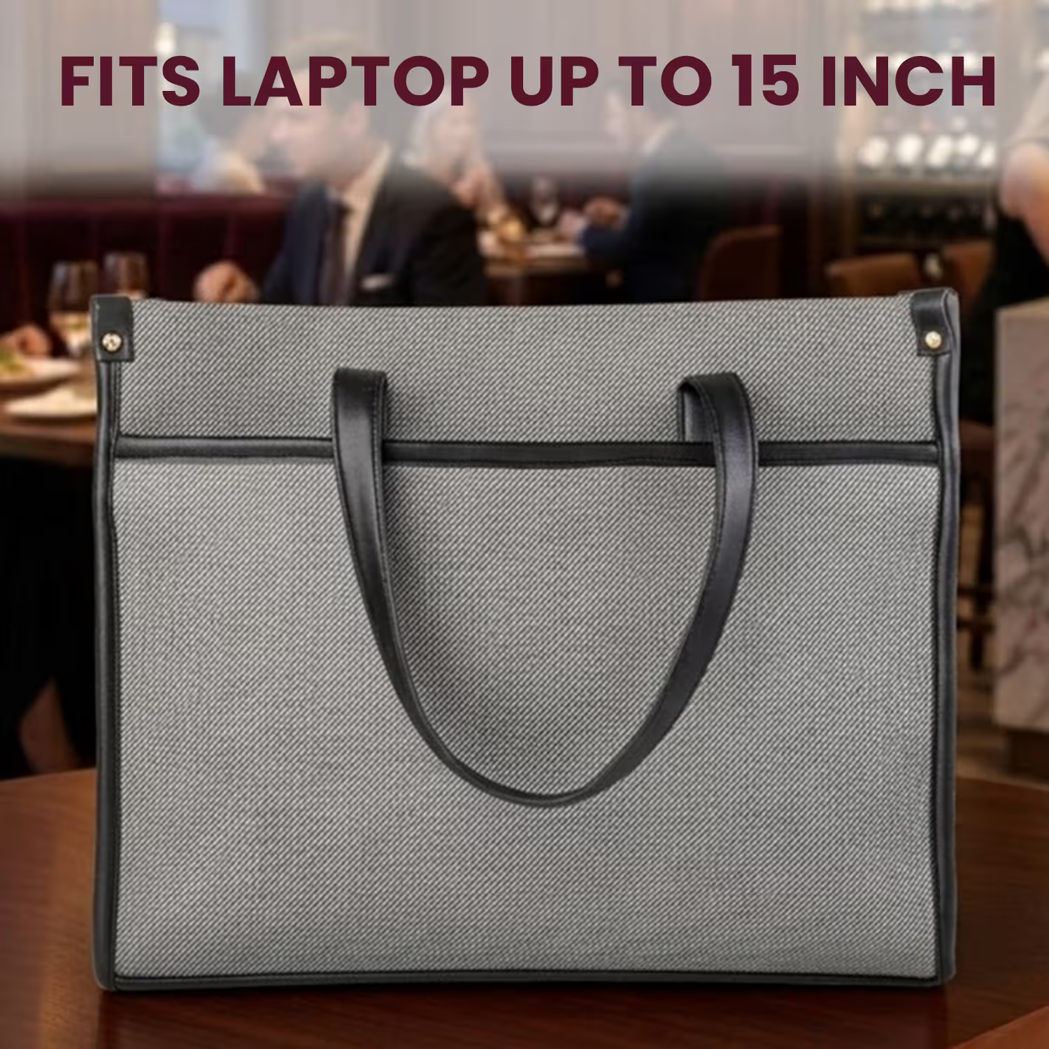 Gray laptop bag with black handles on a blurred restaurant background