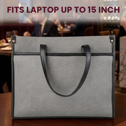 Gray laptop bag with black handles on a blurred restaurant background