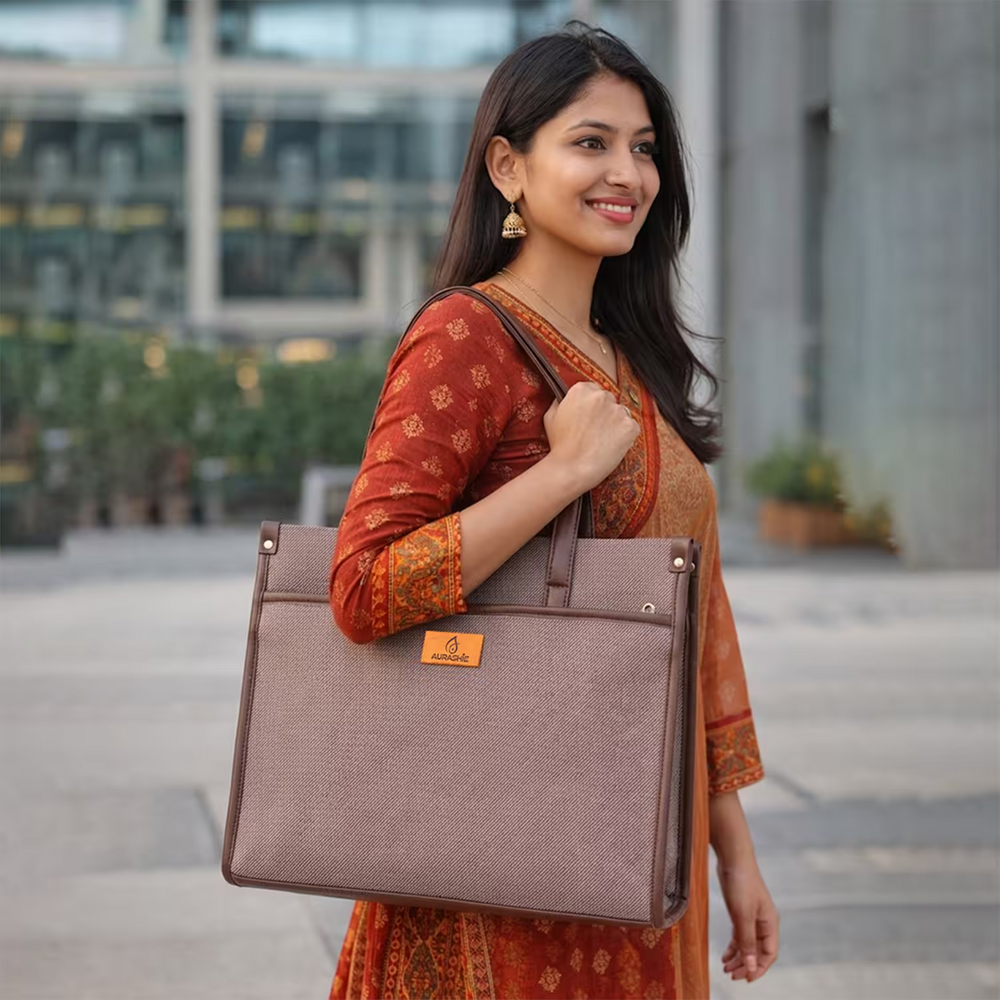 Woman holding a brown tote bag in an urban setting