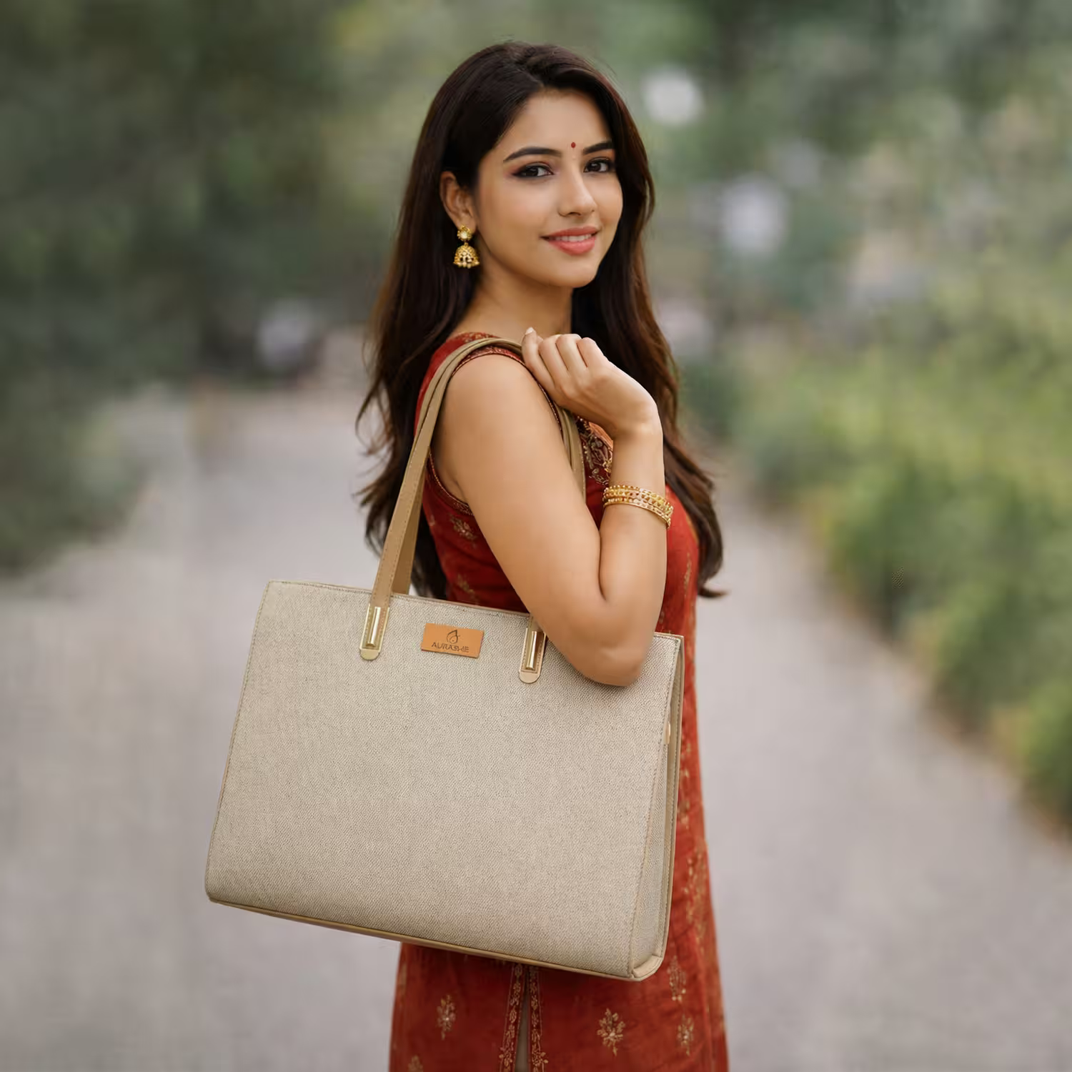 Woman holding a beige handbag outdoors with a blurred natural background